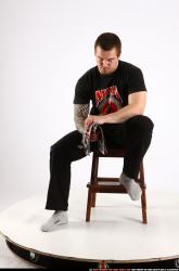 Alex Sitting With Pistol Pose